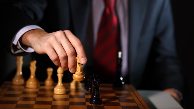 businessman playing chess strategy.jpg